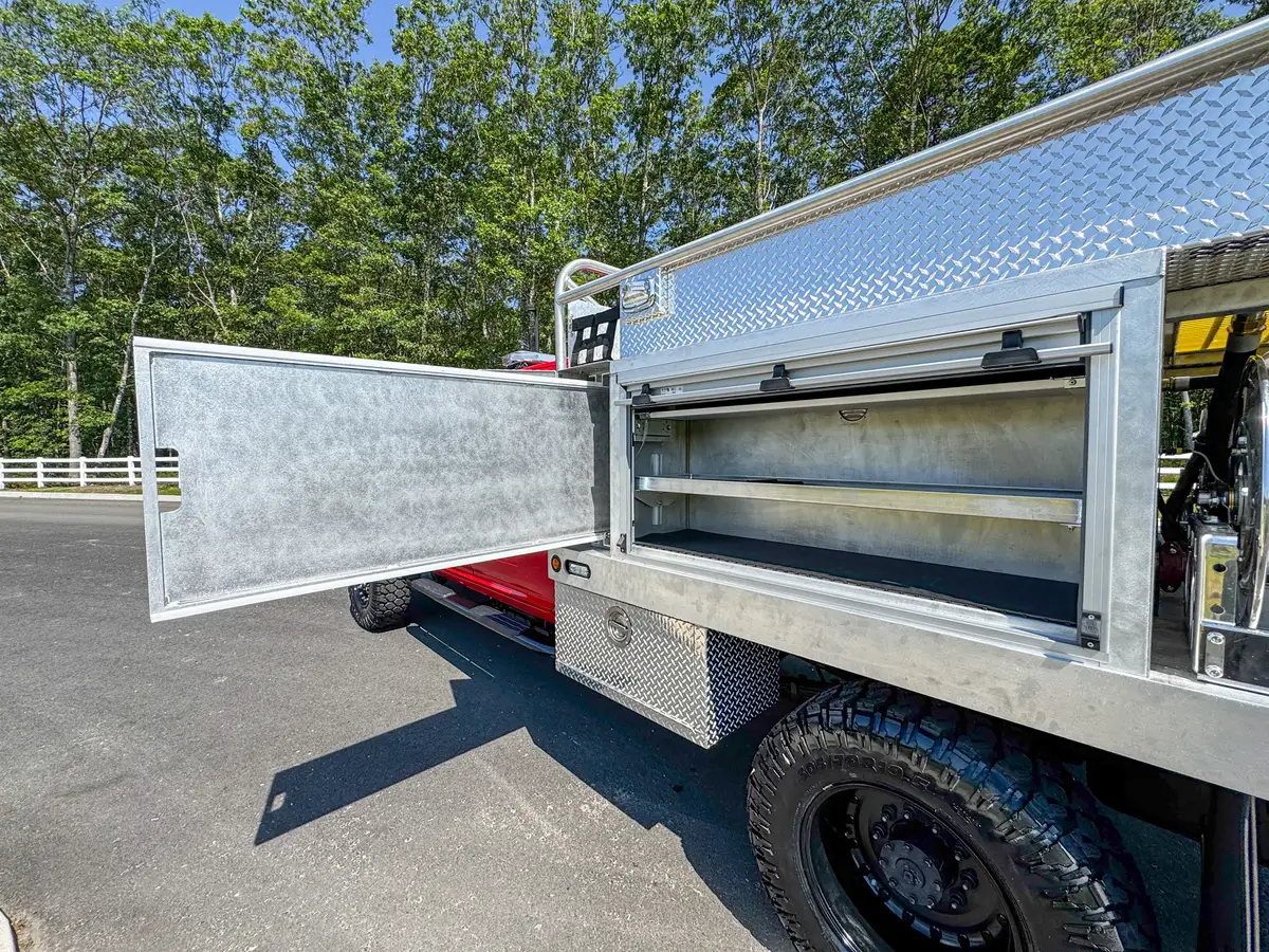 Open side storage bay view from rear angle with long shelf visible.